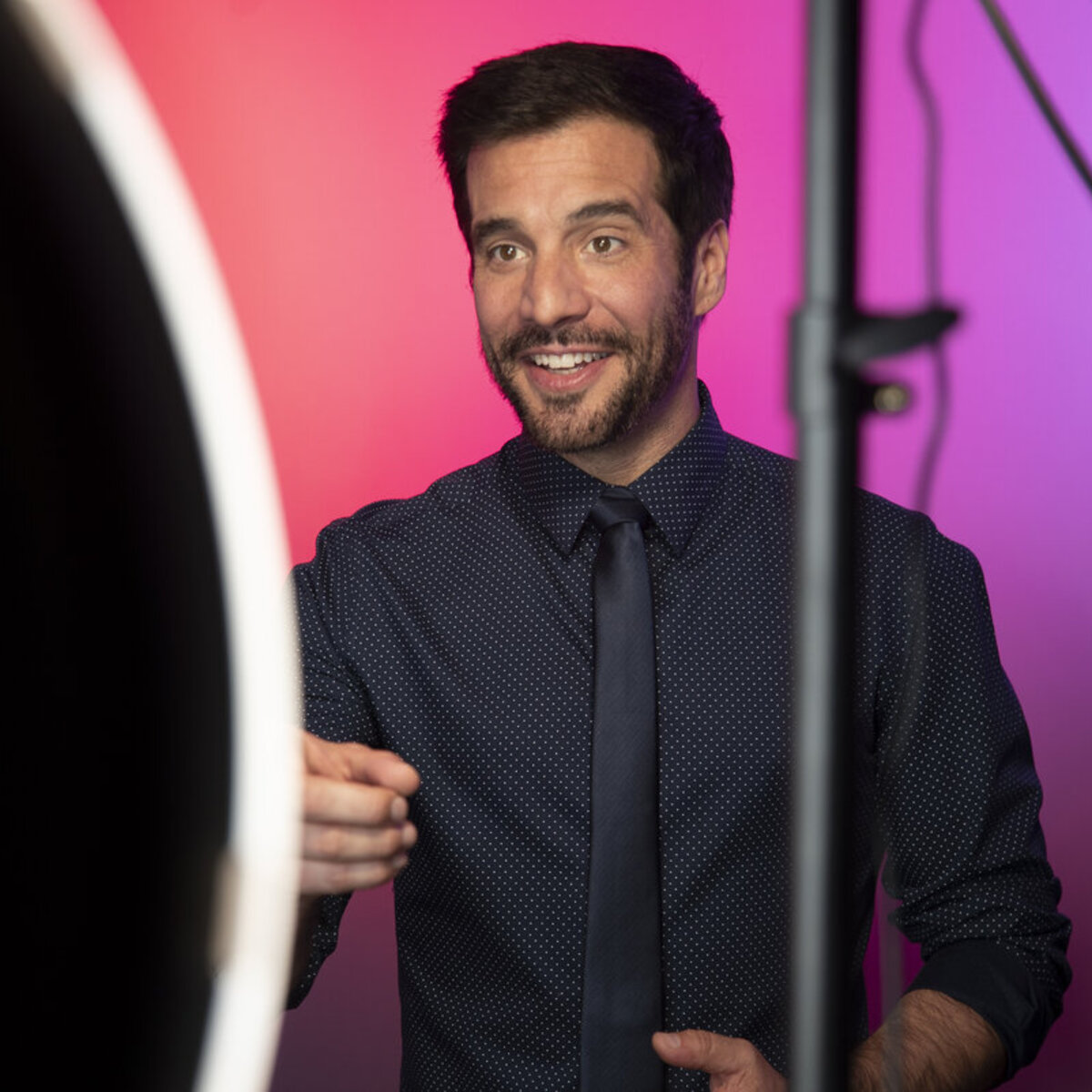 JD Roberto on set with studio lighting