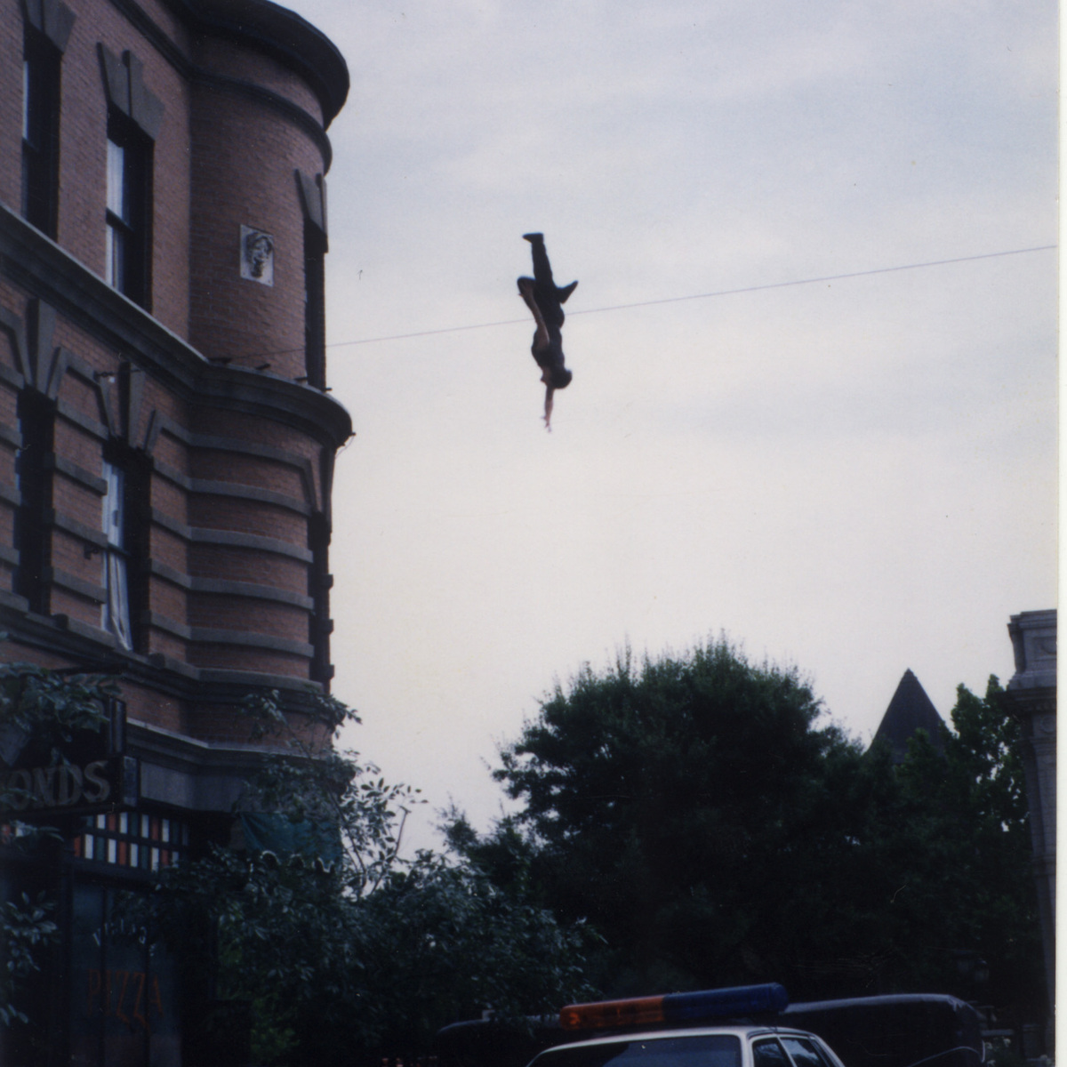 JD Roberto performing a high fall stunt over a police car